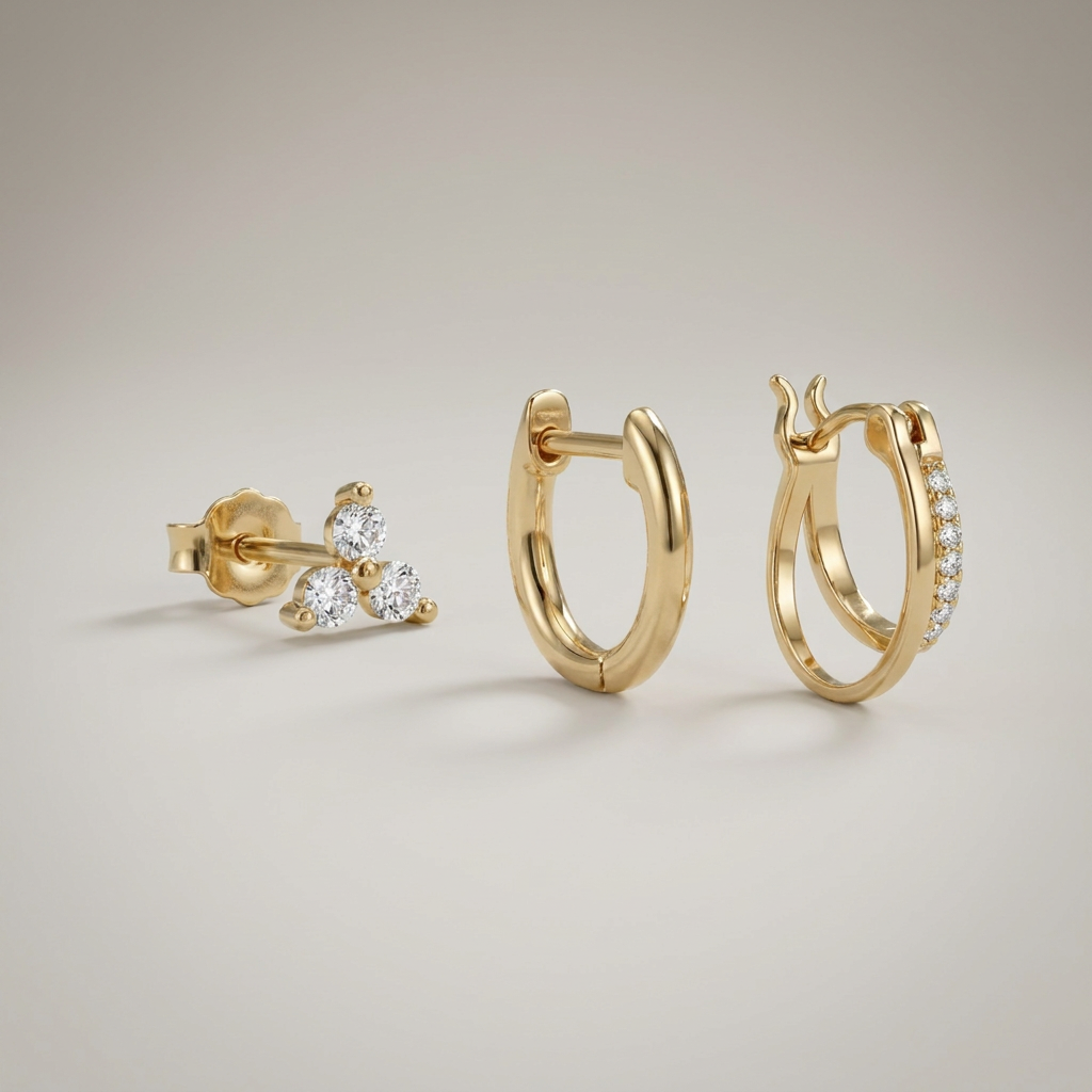 Gold-tone clover hoop earring set on a grey background