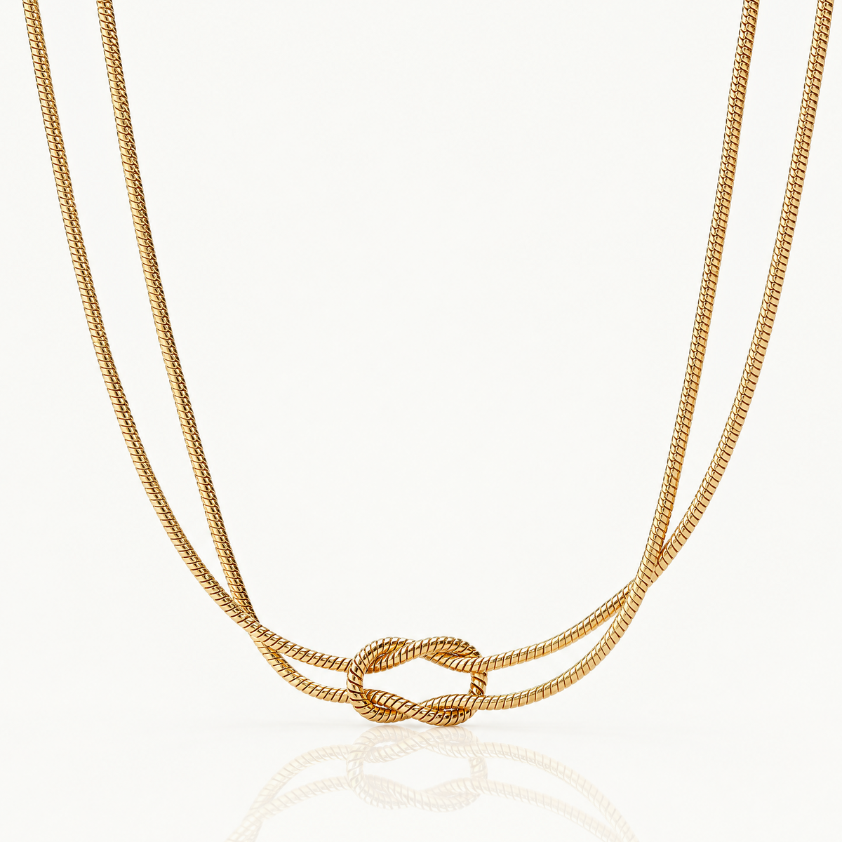 Gold-tone knot necklace with a double snake chain