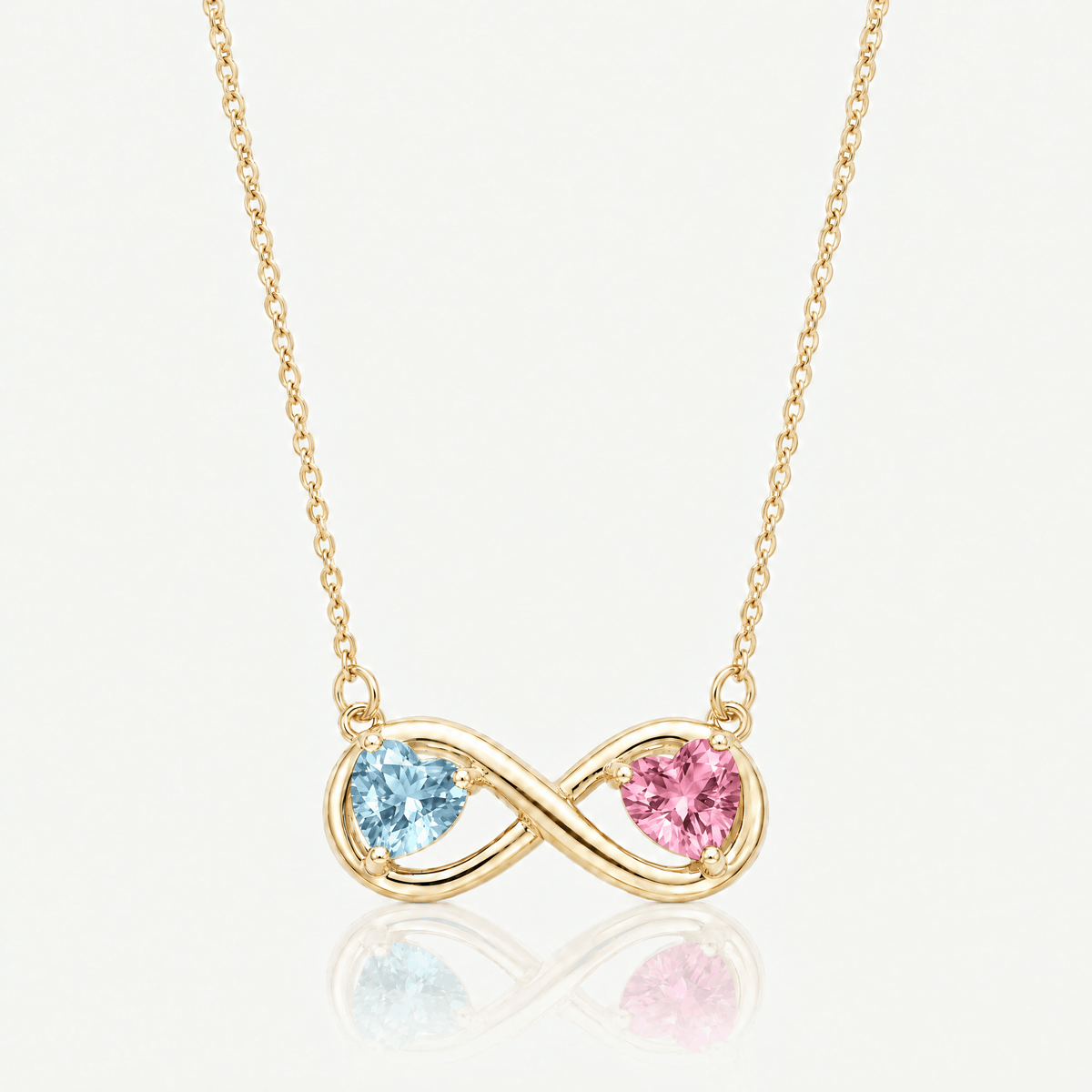 Gold-tone infinity necklace shown with different birthstone heart combinations