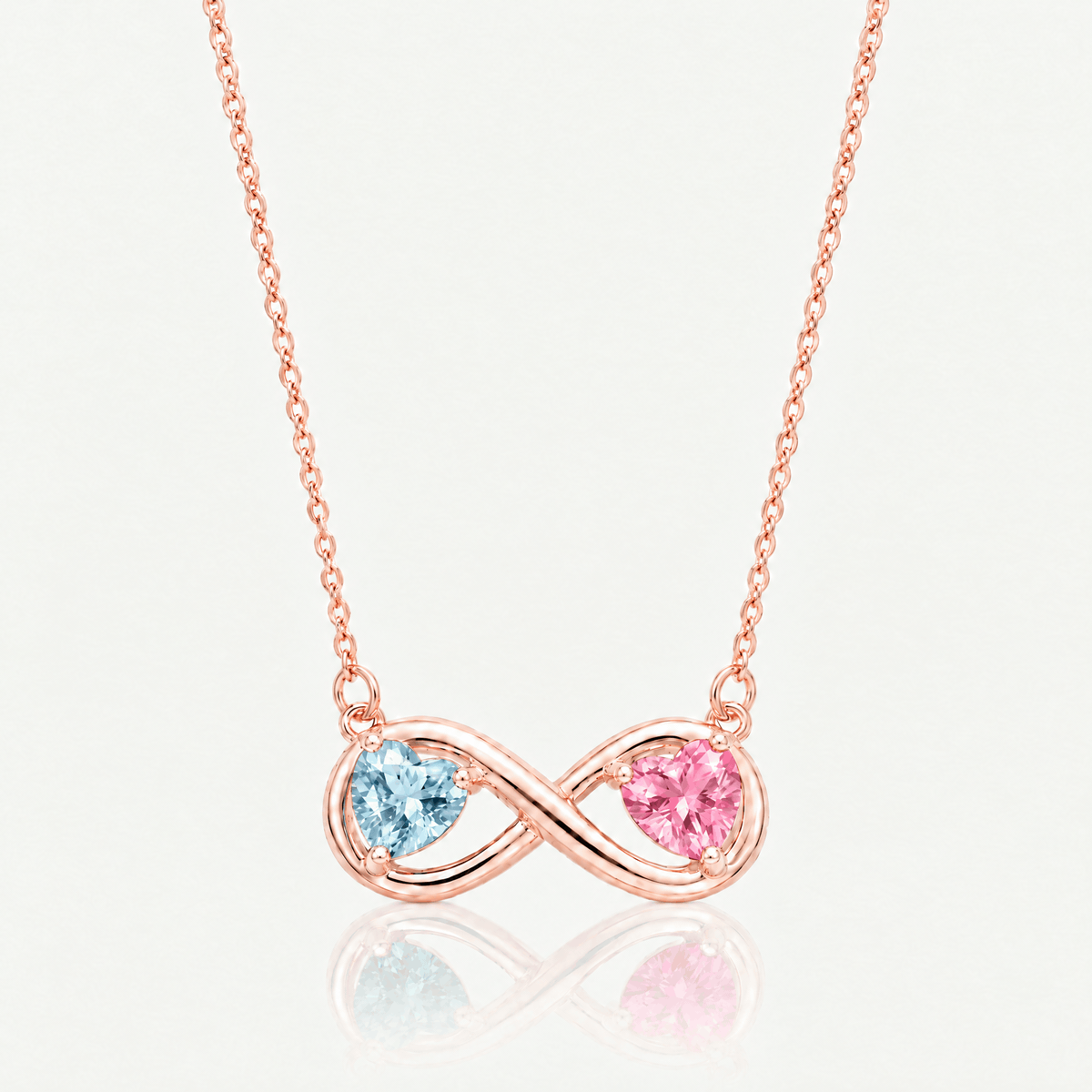 Rose gold-tone infinity necklace shown with different birthstone heart combinations