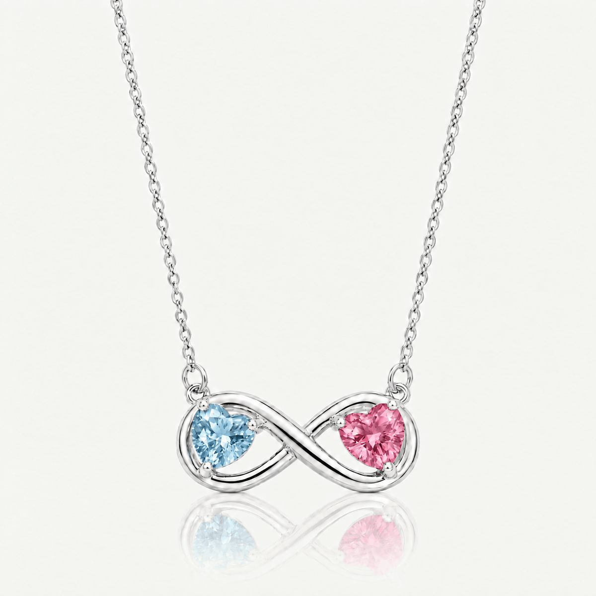 Silver-tone infinity necklace shown with different birthstone heart combinations