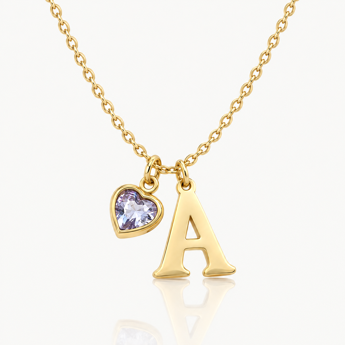 Gold-tone initial necklace with letter A pendant and lavender heart birthstone