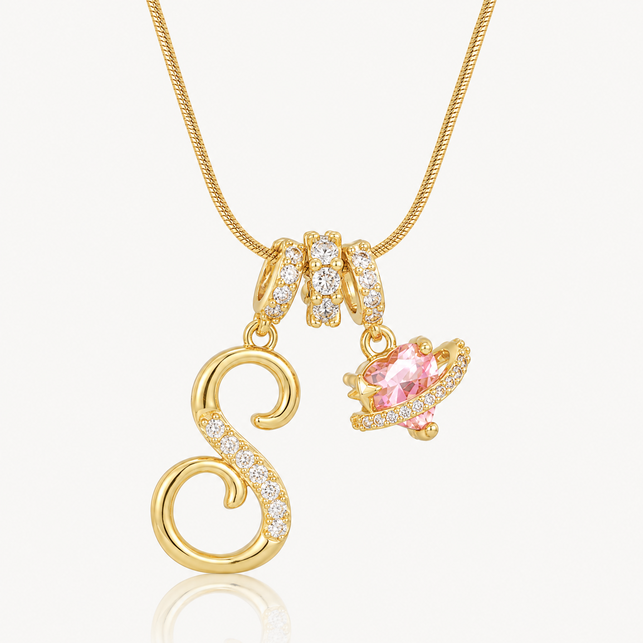 Gold-tone script initial necklace with pink flower charm