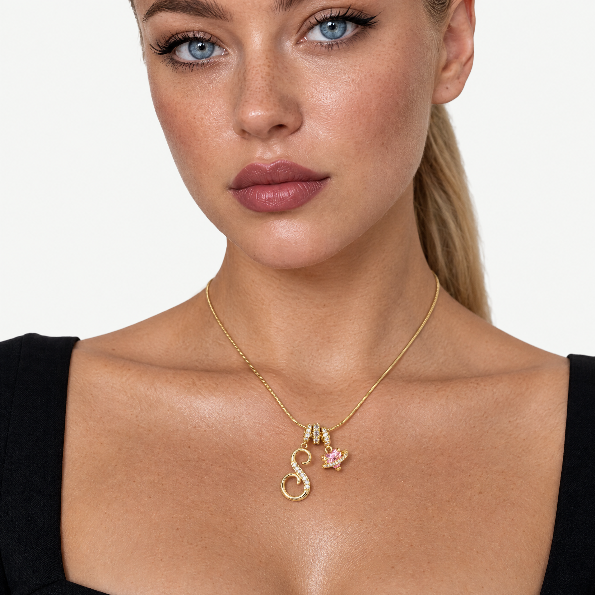 Gold-tone script initial necklace with pink flower charm
