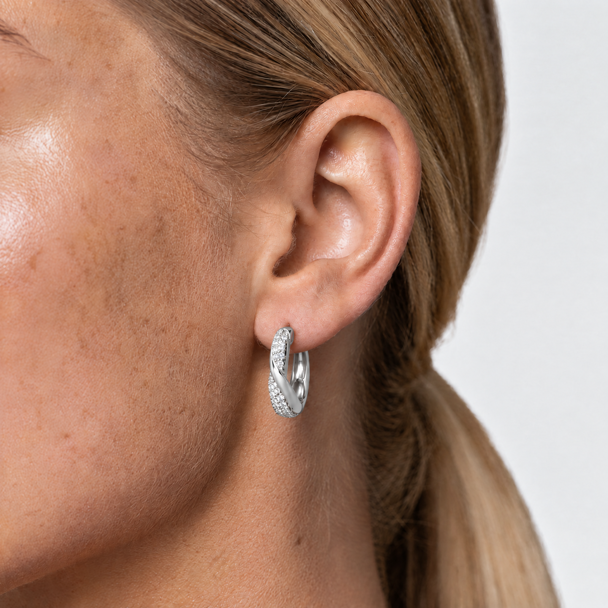 Twisted crystal huggie hoop earrings silver-tone