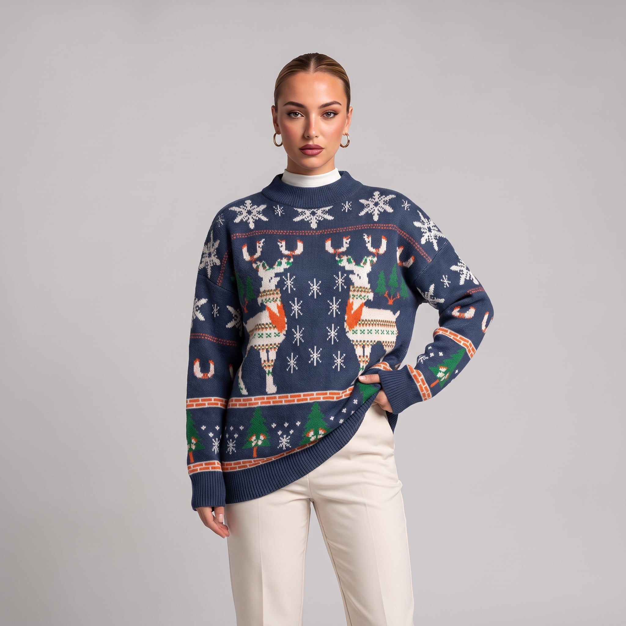 Close-up of navy oversized knit jumper with reindeer, snowflake and tree pattern