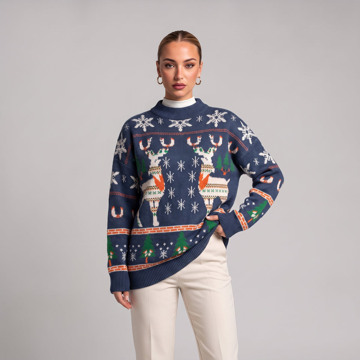 Close-up of navy oversized knit jumper with reindeer, snowflake and tree pattern