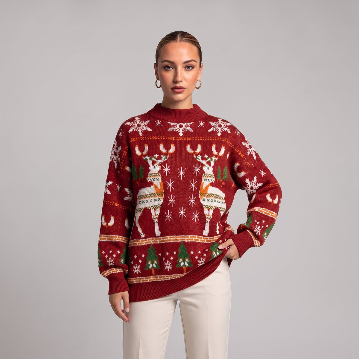 Close-up of red oversized knit jumper with reindeer, snowflake and tree pattern