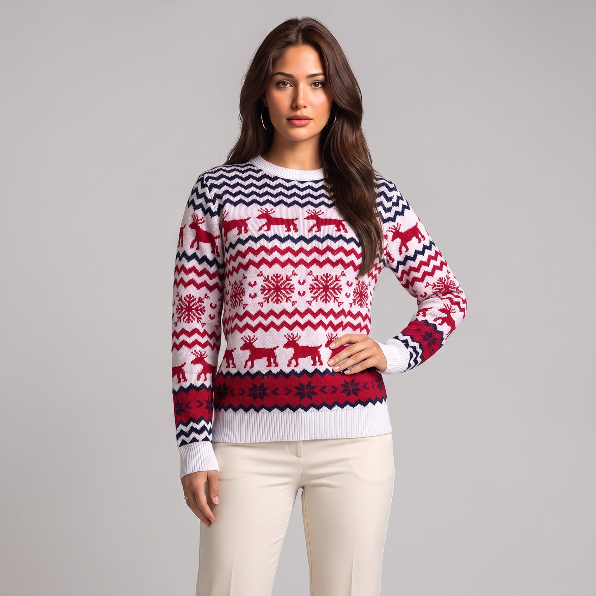 Close-up of white knit jumper with red reindeer, navy zigzag and snowflake rows