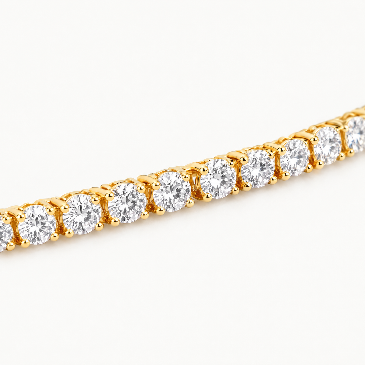 Close up of the four-prong settings of the gold plated tennis bracelet