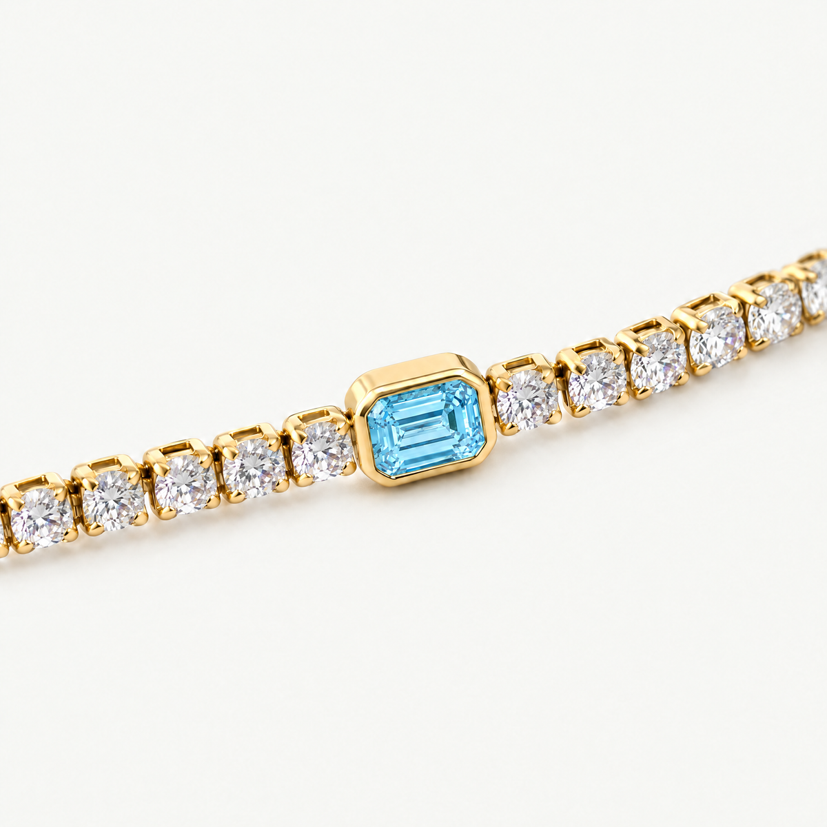 Close up of the blue emerald-cut centre stone in its smooth bezel