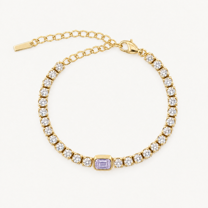 Gold-tone tennis bracelet with purple centre stone and extender chain, laid flat