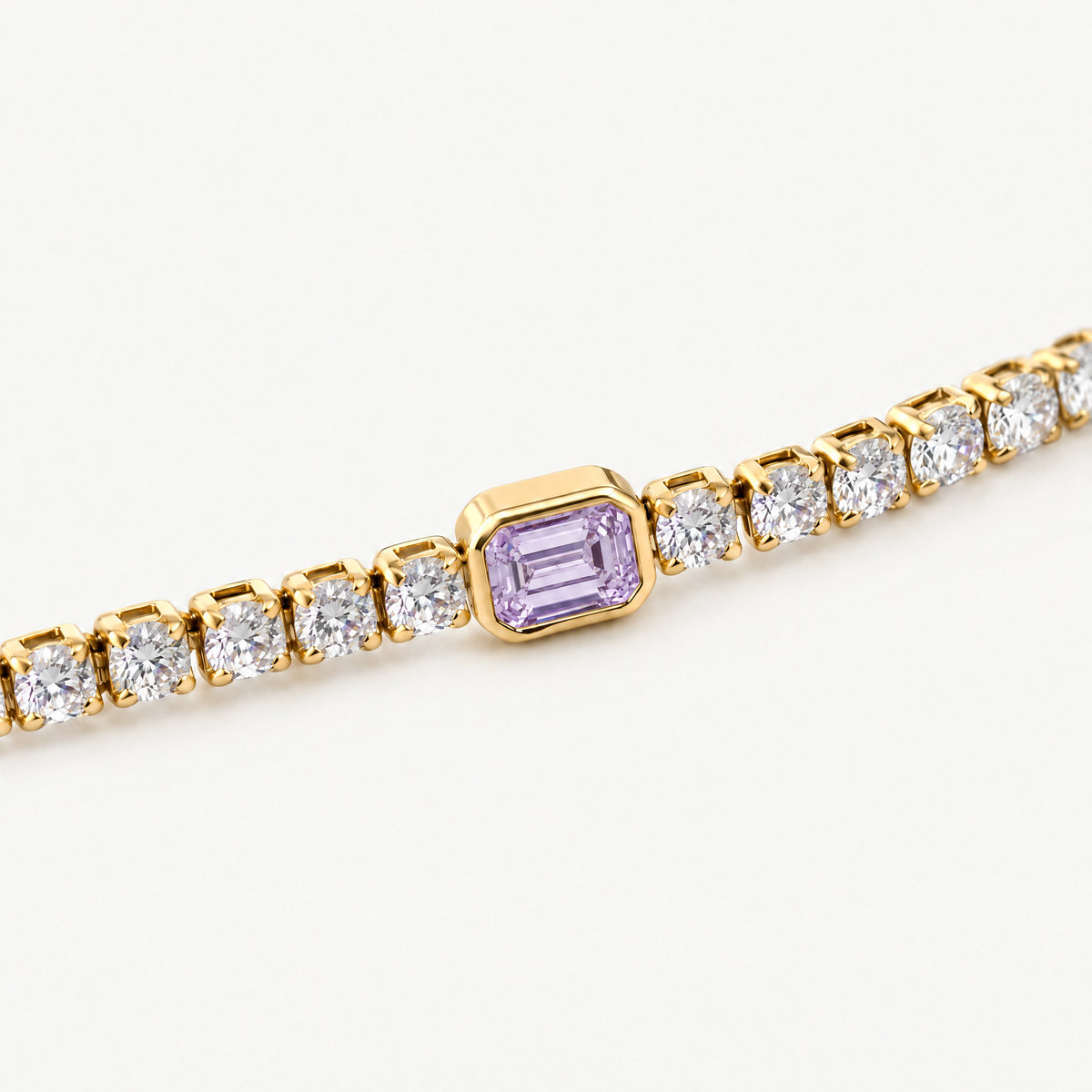 Close up of the purple emerald-cut centre stone in its smooth bezel
