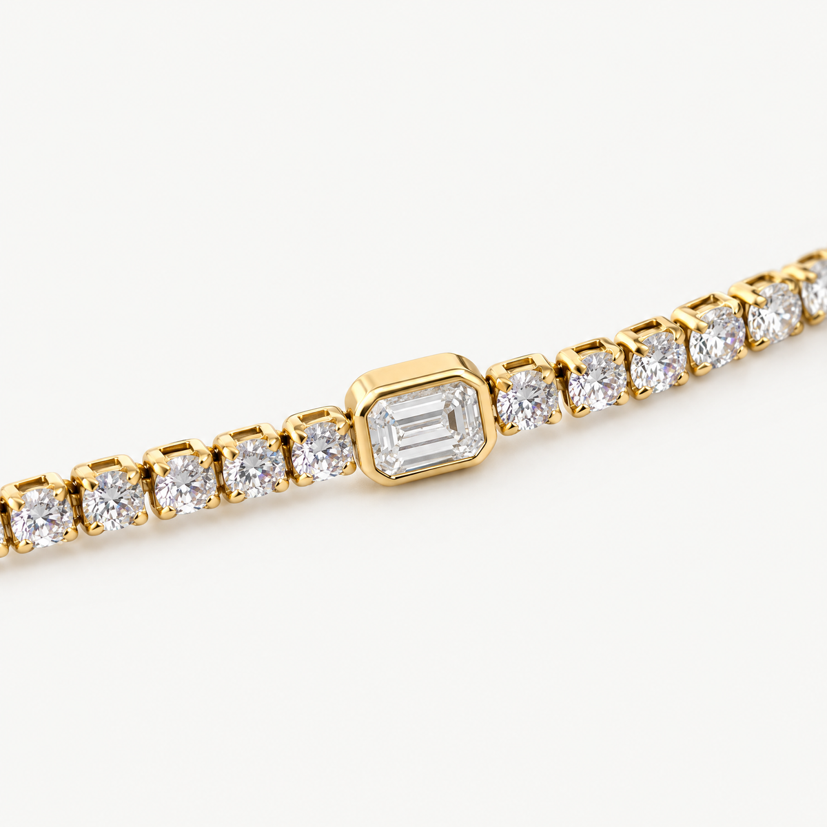 Close up of the emerald-cut centre stone in its smooth bezel