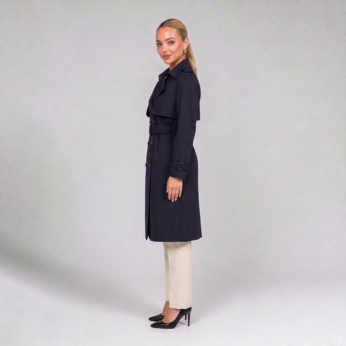 Navy double breasted trench coat with belt, side view on model