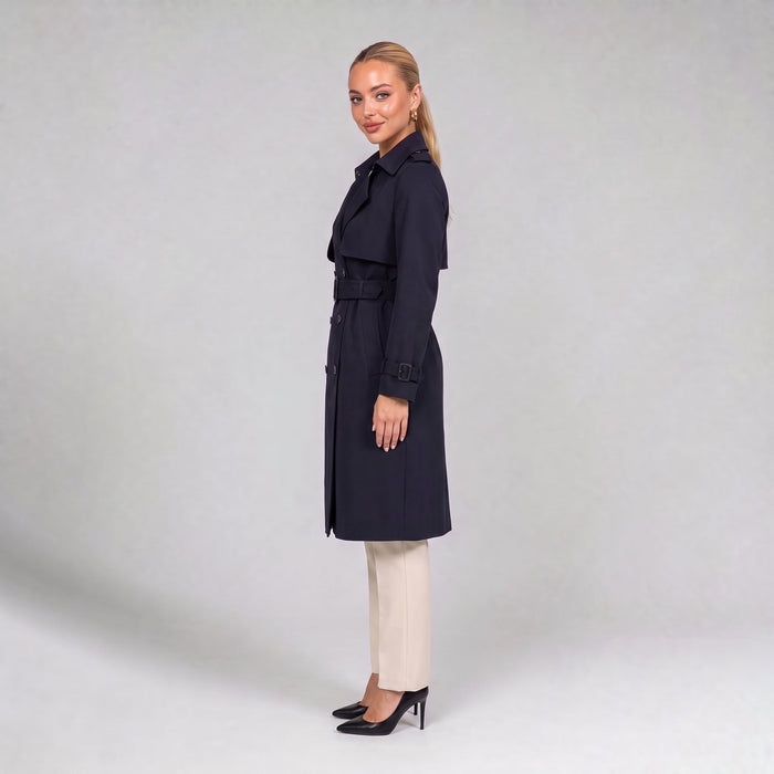 Navy double breasted trench coat with belt, side view on model