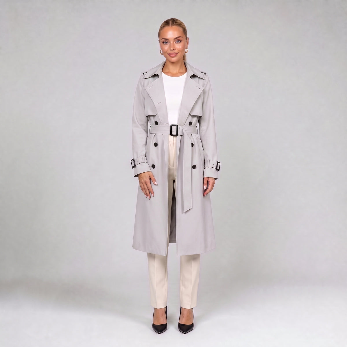 Off white double breasted trench coat with belt, front view on model