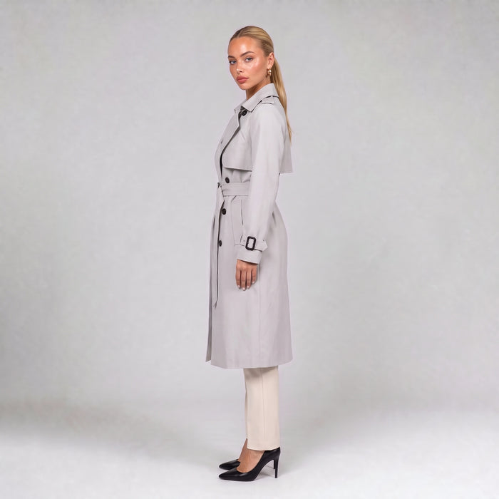 Off white double breasted trench coat with belt, side view on model