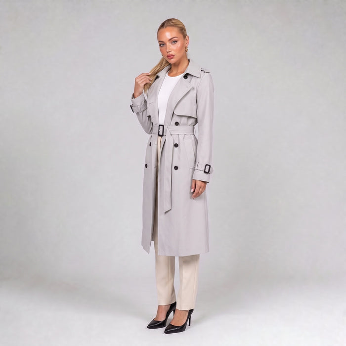 Off white double breasted trench coat with belt, three quarter view on model