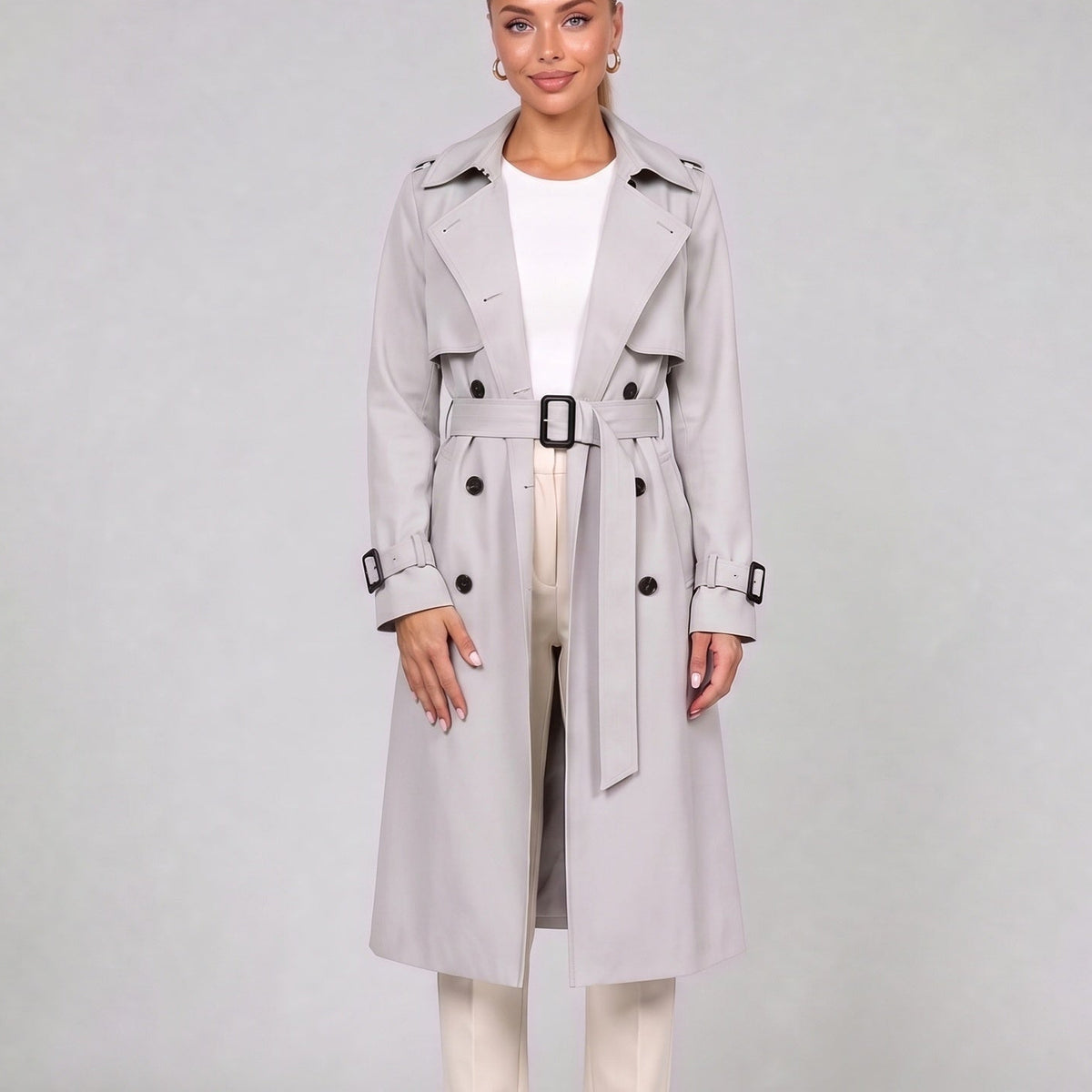Off white double breasted trench coat with belt, front view on model