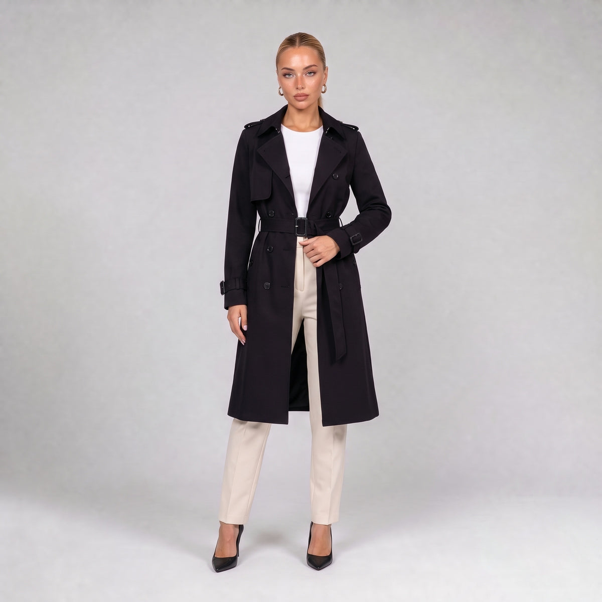 Black double breasted trench coat with belt, front view on model
