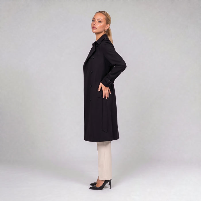 Black double breasted trench coat with belt, side view on model