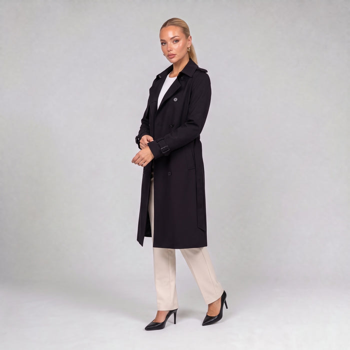 Black double breasted trench coat with belt, three quarter view on model