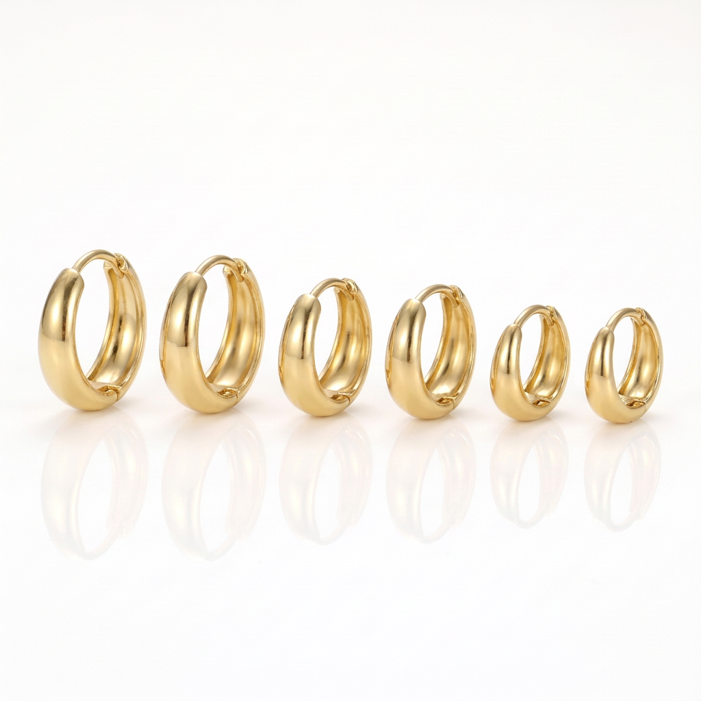 Three pairs of gold-tone chunky hoop earrings in three sizes