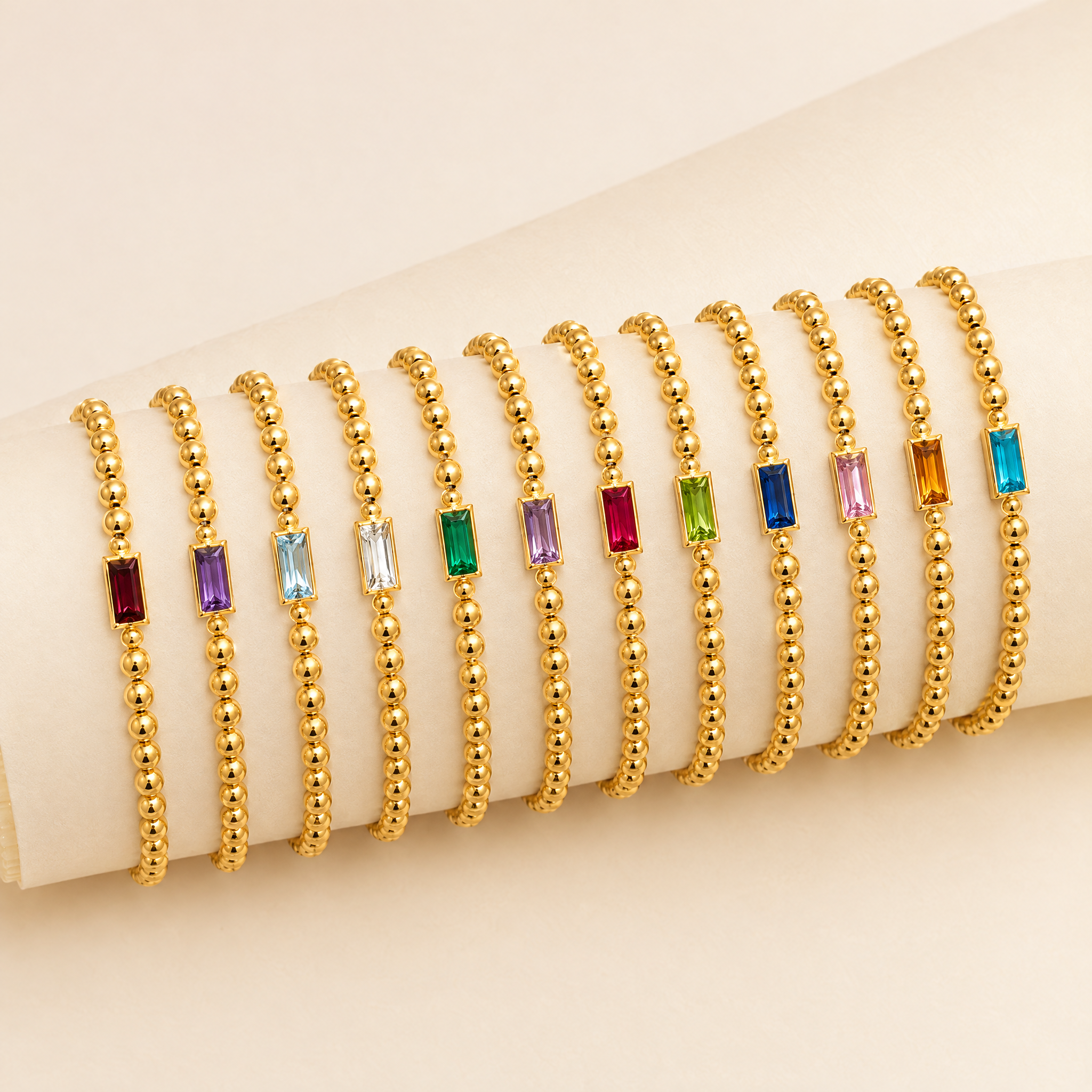Twelve beaded birthstone bracelets, one baguette colour for each month