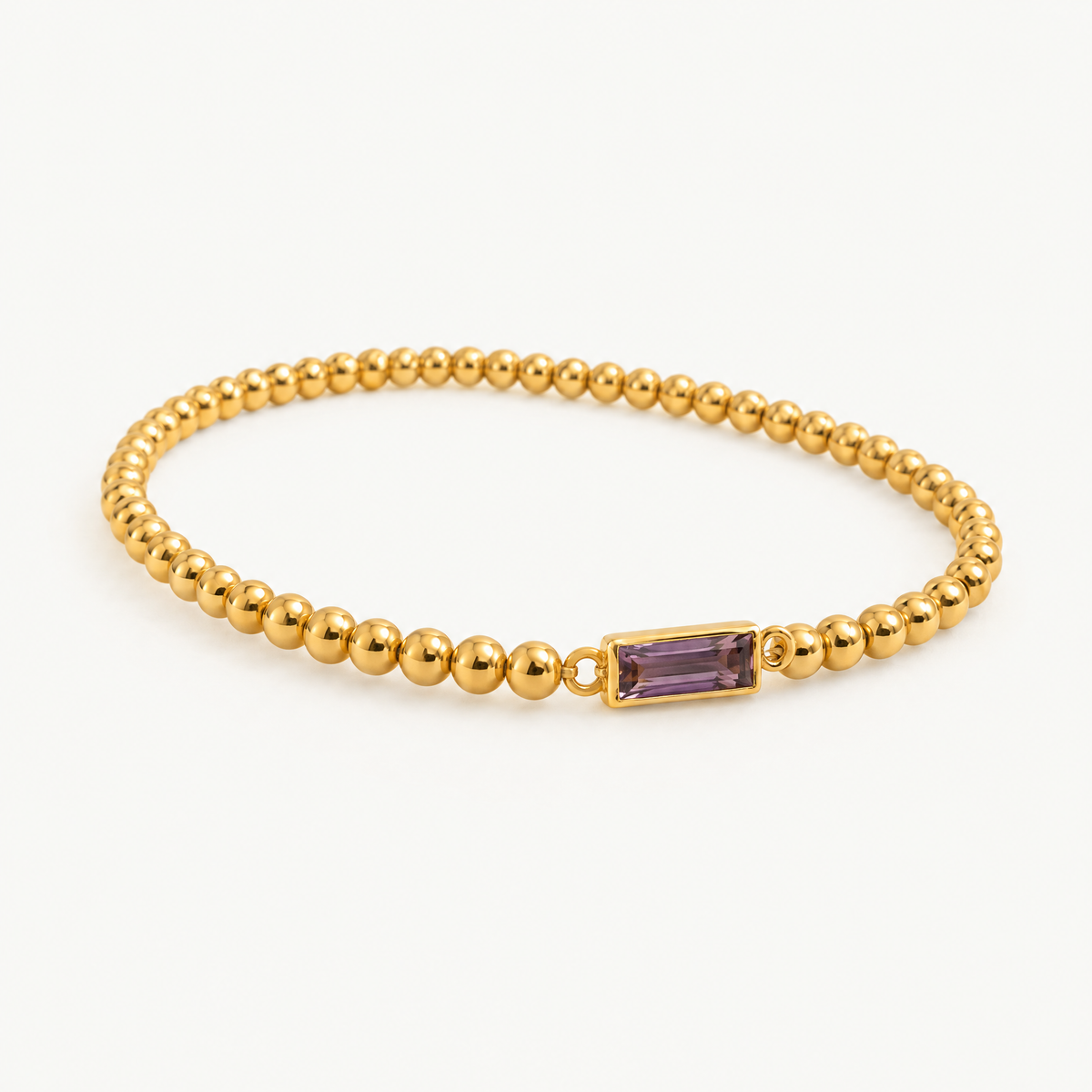 Beaded birthstone bracelet with a purple baguette stone, angled view