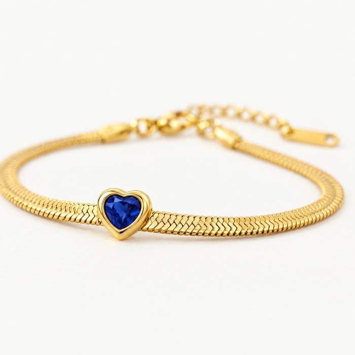 Snake chain birthstone bracelet with a blue heart, angled view