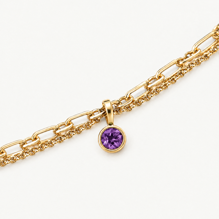 Close up of the round purple birthstone charm on the layered chain