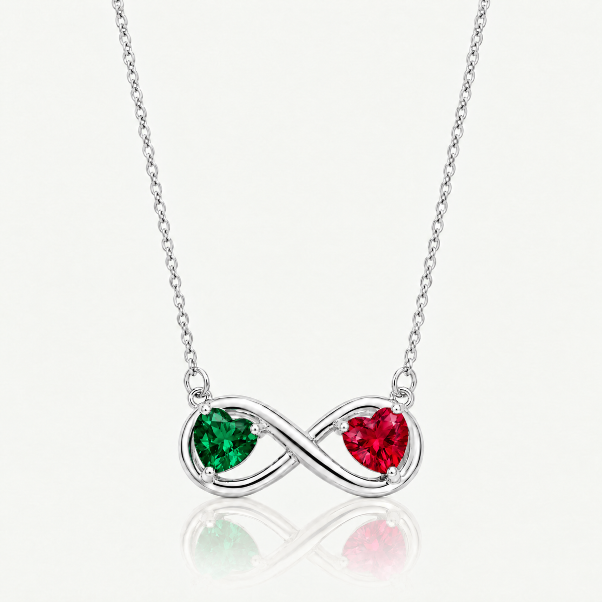 Silver-tone infinity necklace with emerald green and ruby red birthstone hearts