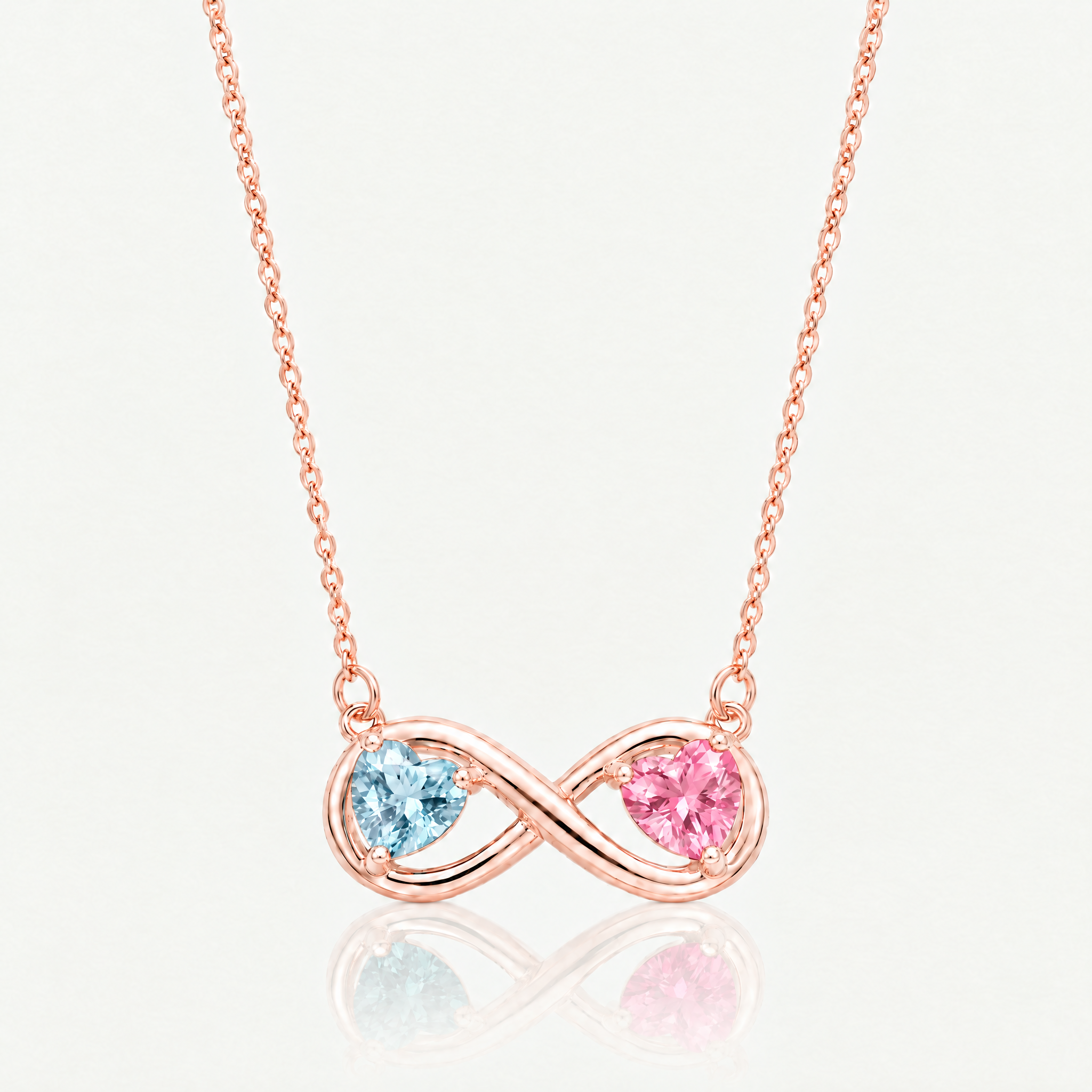 Rose gold-tone infinity necklace with light blue and pink birthstone hearts