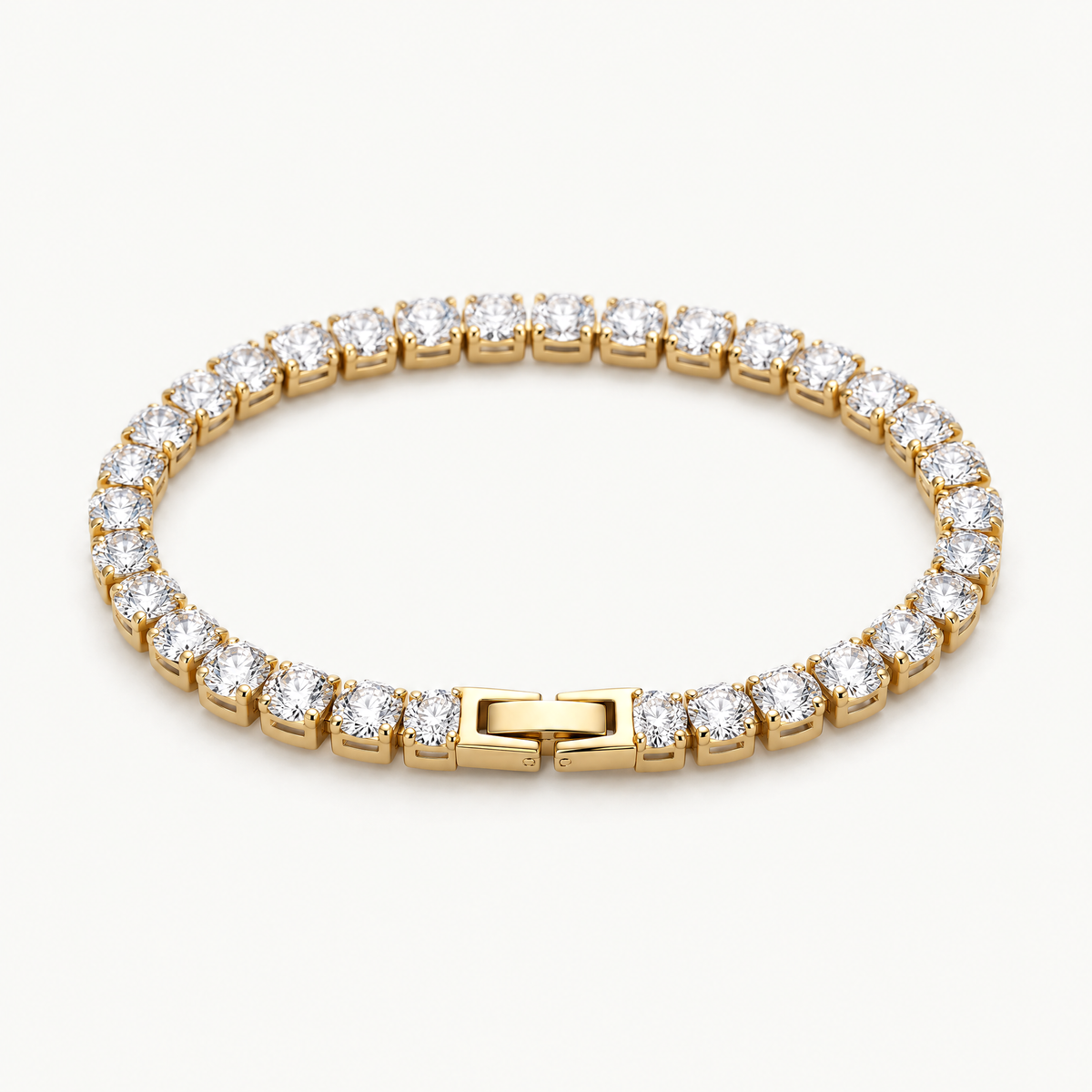 Gold-tone cubic zirconia tennis bracelet with box clasp, angled view
