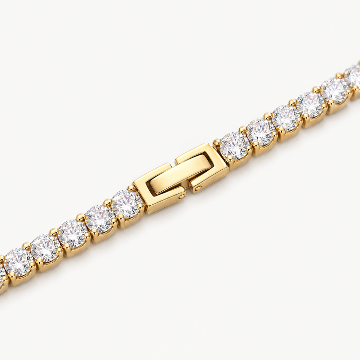 Close up of the claw-set stones and box clasp of the gold-tone tennis bracelet