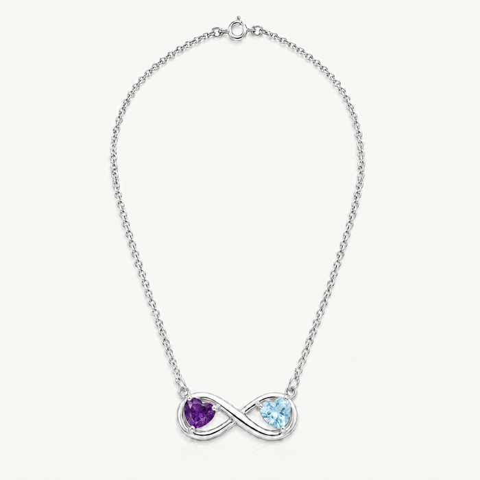 Full length of the silver-tone infinity necklace with amethyst and aquamarine hearts, laid flat