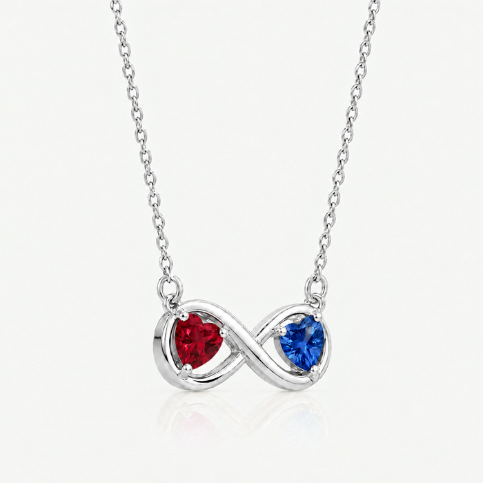 Silver-tone infinity pendant with ruby red and sapphire blue hearts, angled view