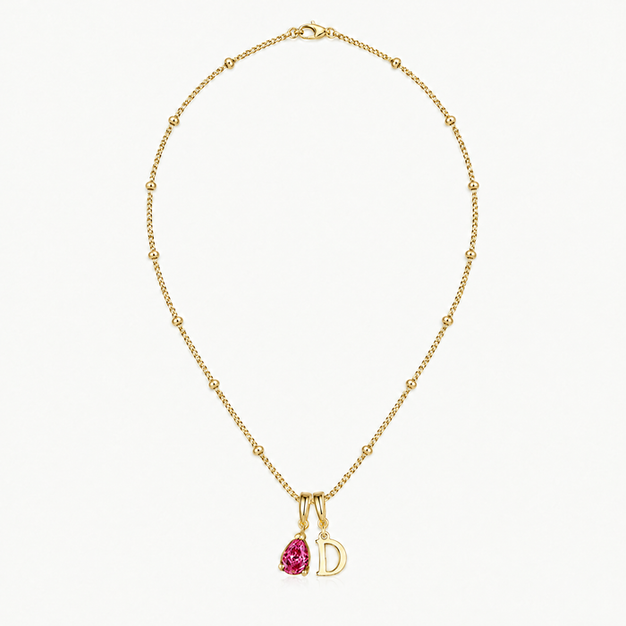 Full length of the gold-tone satellite chain initial necklace with letter D, laid flat