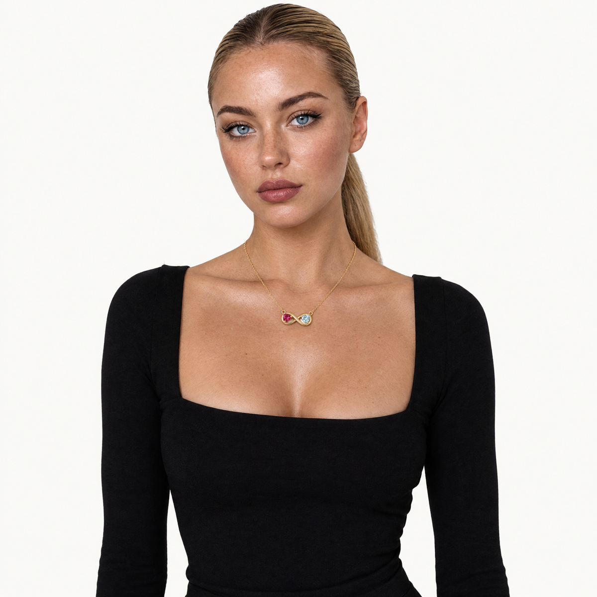 Model in a black top wearing the gold-tone infinity birthstone necklace