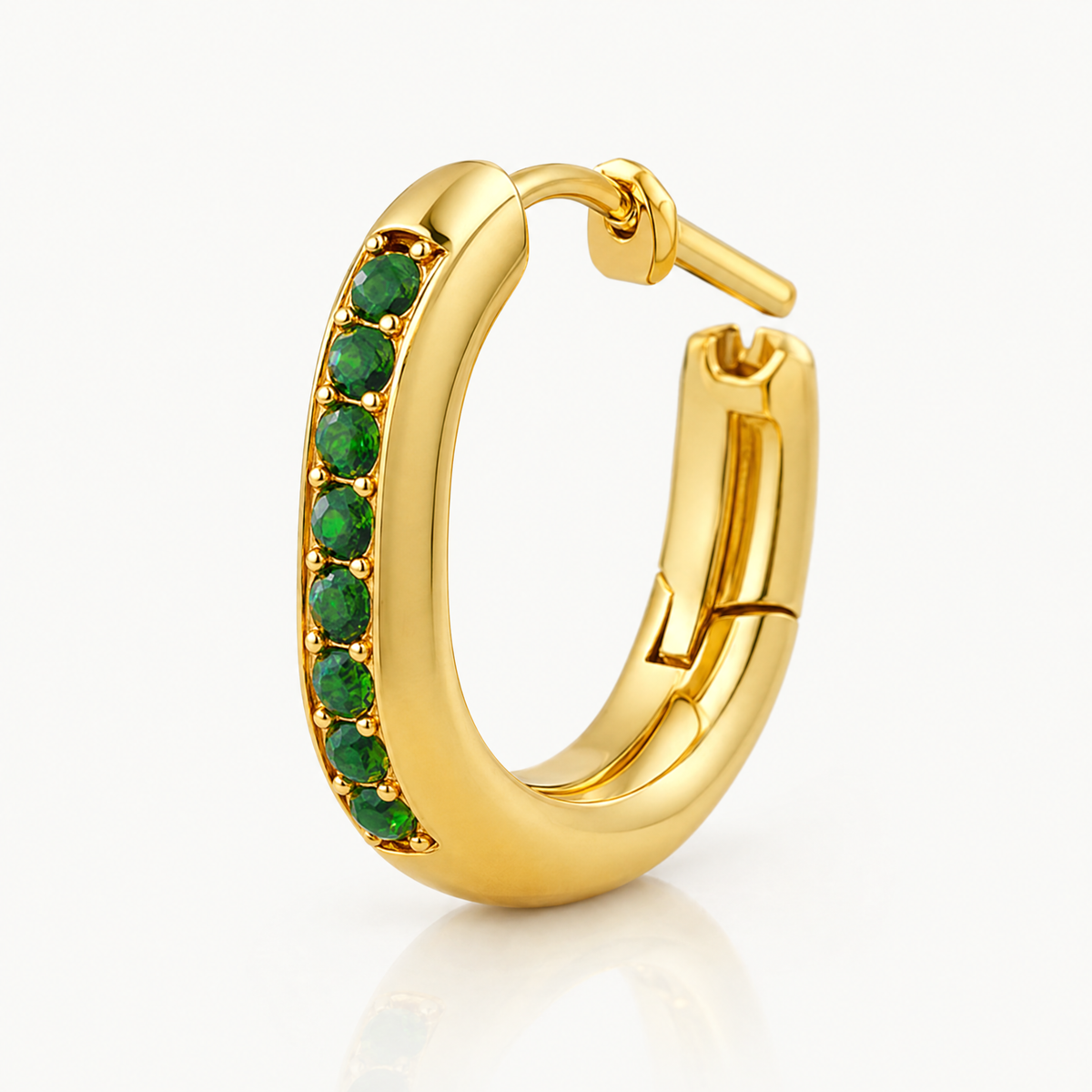 Single oval huggie hoop with green stones, hinged closure open