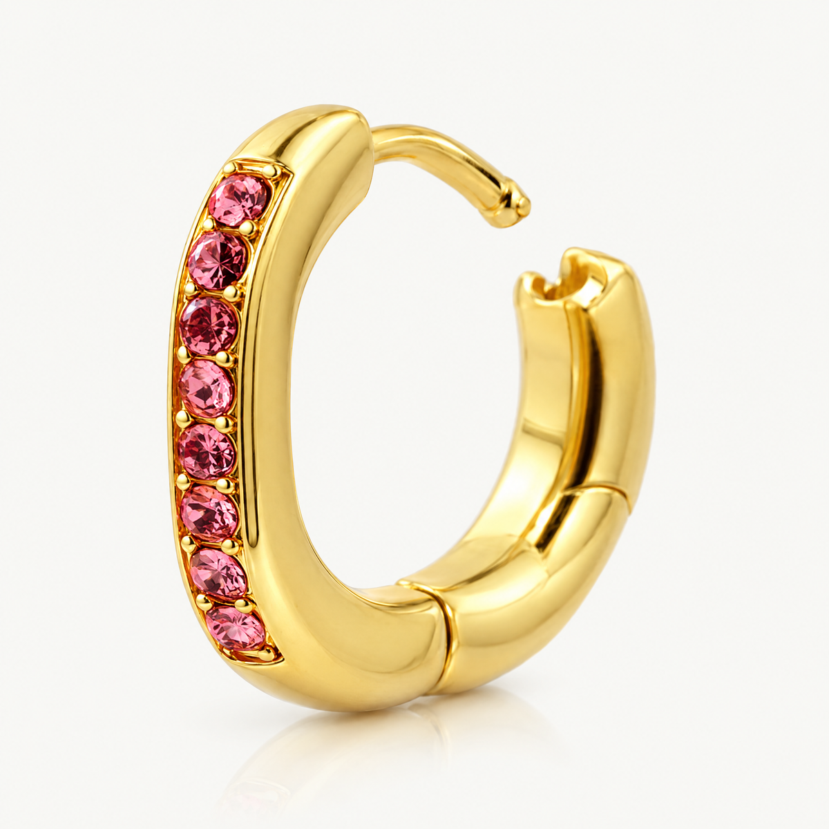 Single oval huggie hoop with pink stones, hinged closure open