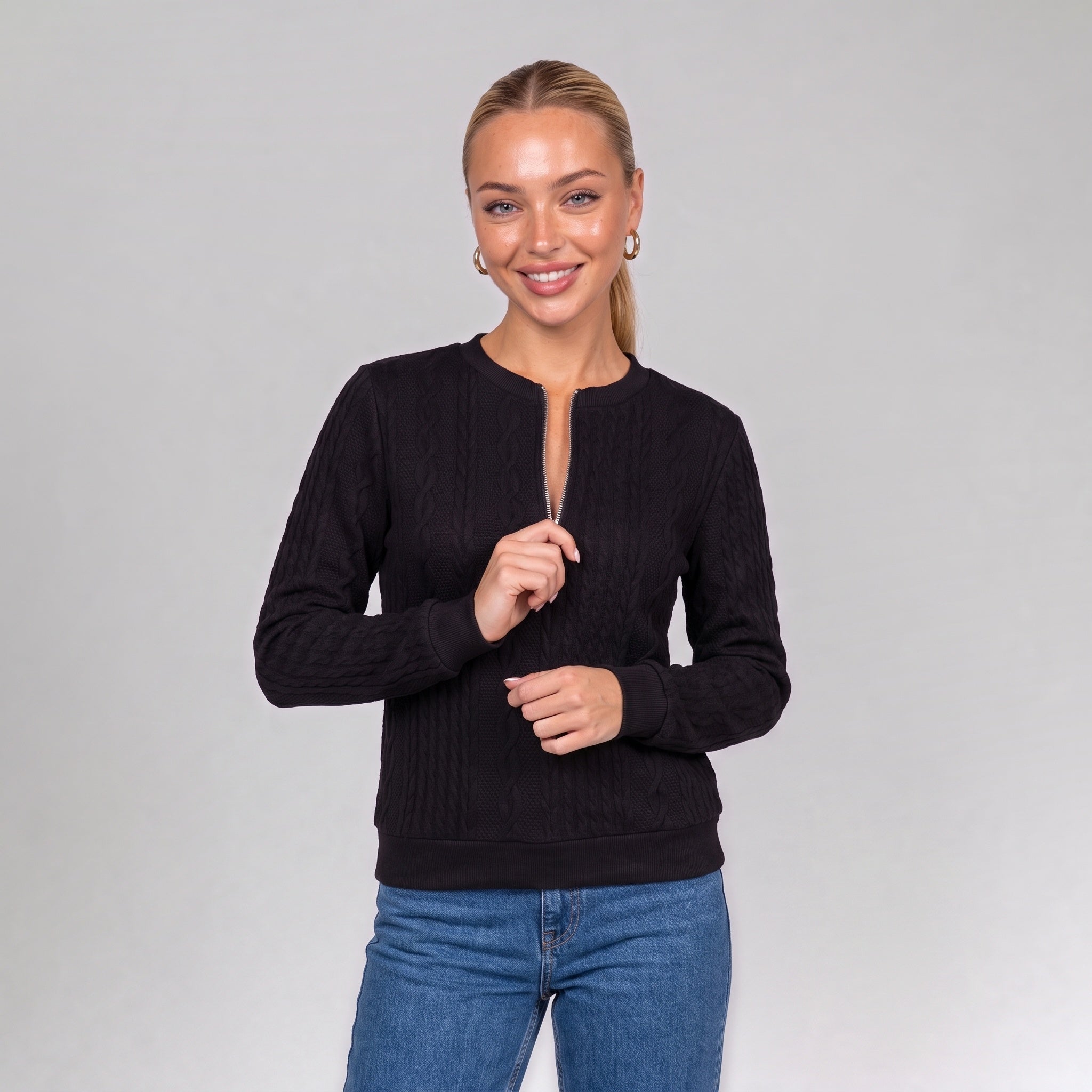 Close up of the black quarter zip cable knit jumper