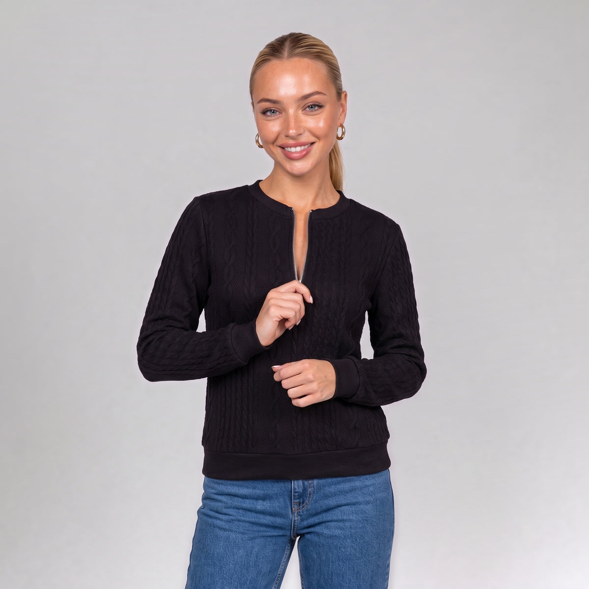 Close up of the black quarter zip cable knit jumper