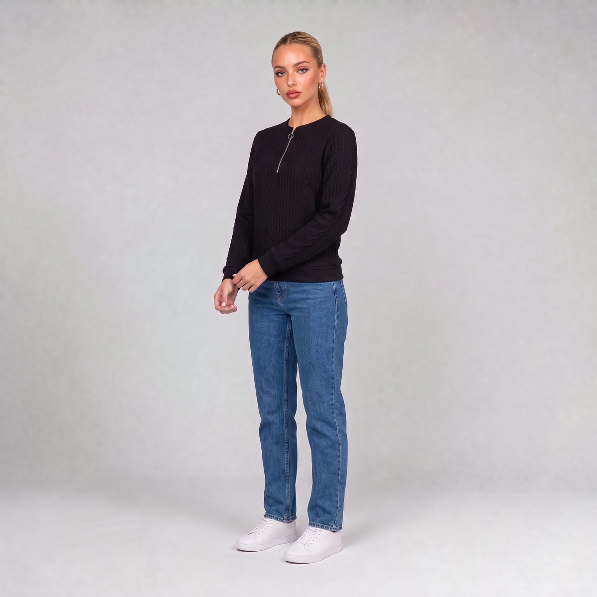 Black quarter zip cable knit jumper, three quarter view on model